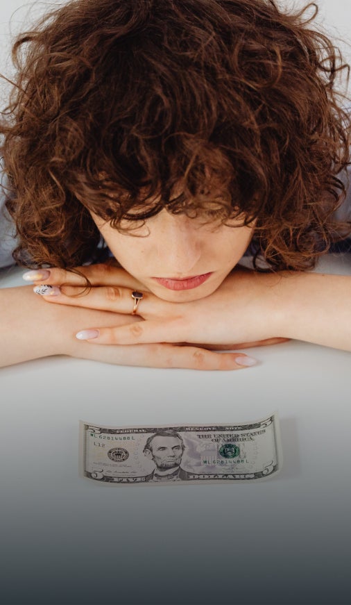 Woman looking at a dollar