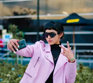 Influencer taking a selfie photo wearing expensive clothes