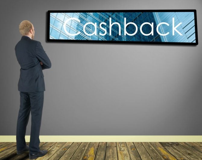 Man looking at Cash back sign