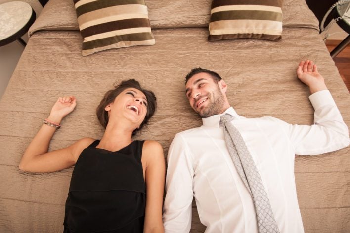 Couple Enjoying Hotel Bed