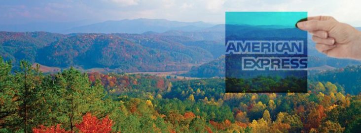 Amex logo against mountains
