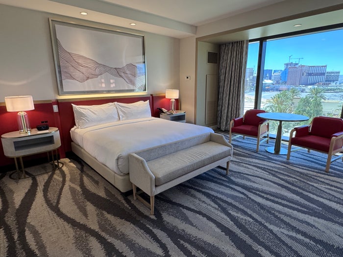 Conrad Las Vegas king room bed with Strip view and seating area
