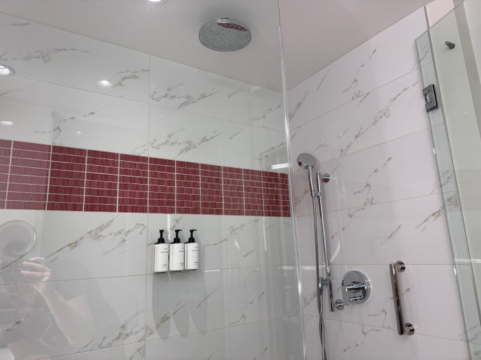 Conrad Las Vegas king room walk in shower with rain head and red tile