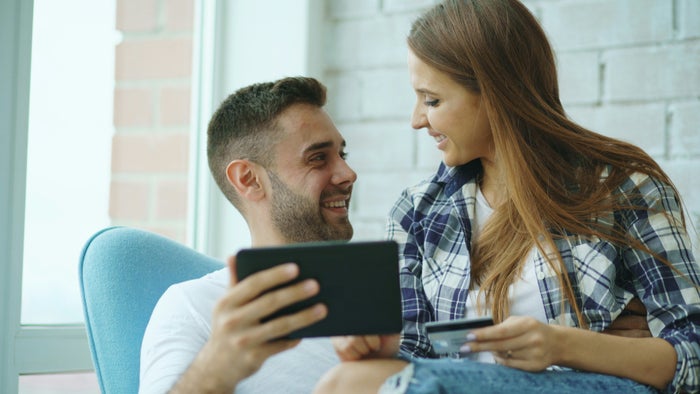Couple with credit card and tablet
