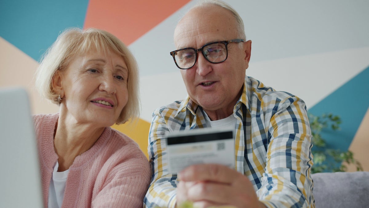 Elderly couple seniors with credit card