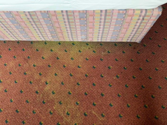 Four Essen faded carpet by bed
