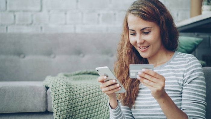 Happy woman credit card phone