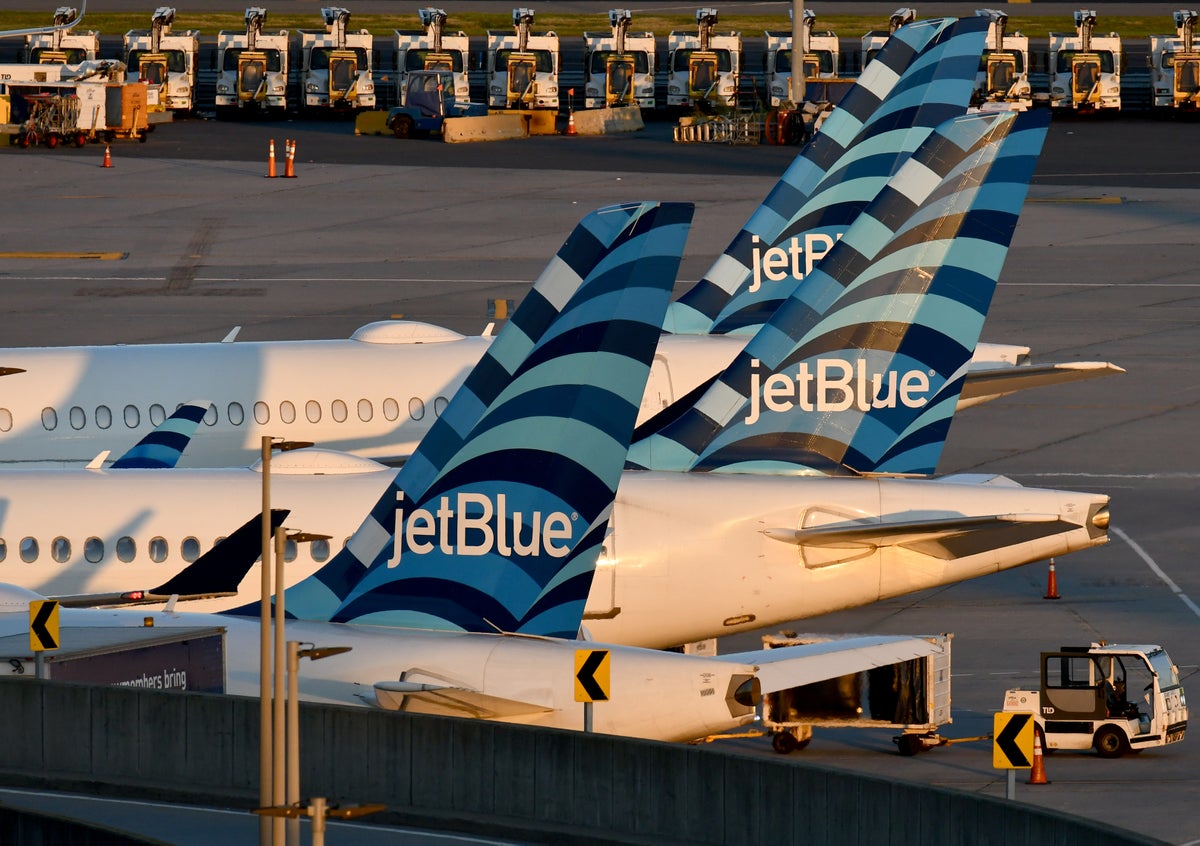 JetBlue A220 300 Tails JFK Terminal 5 sunset