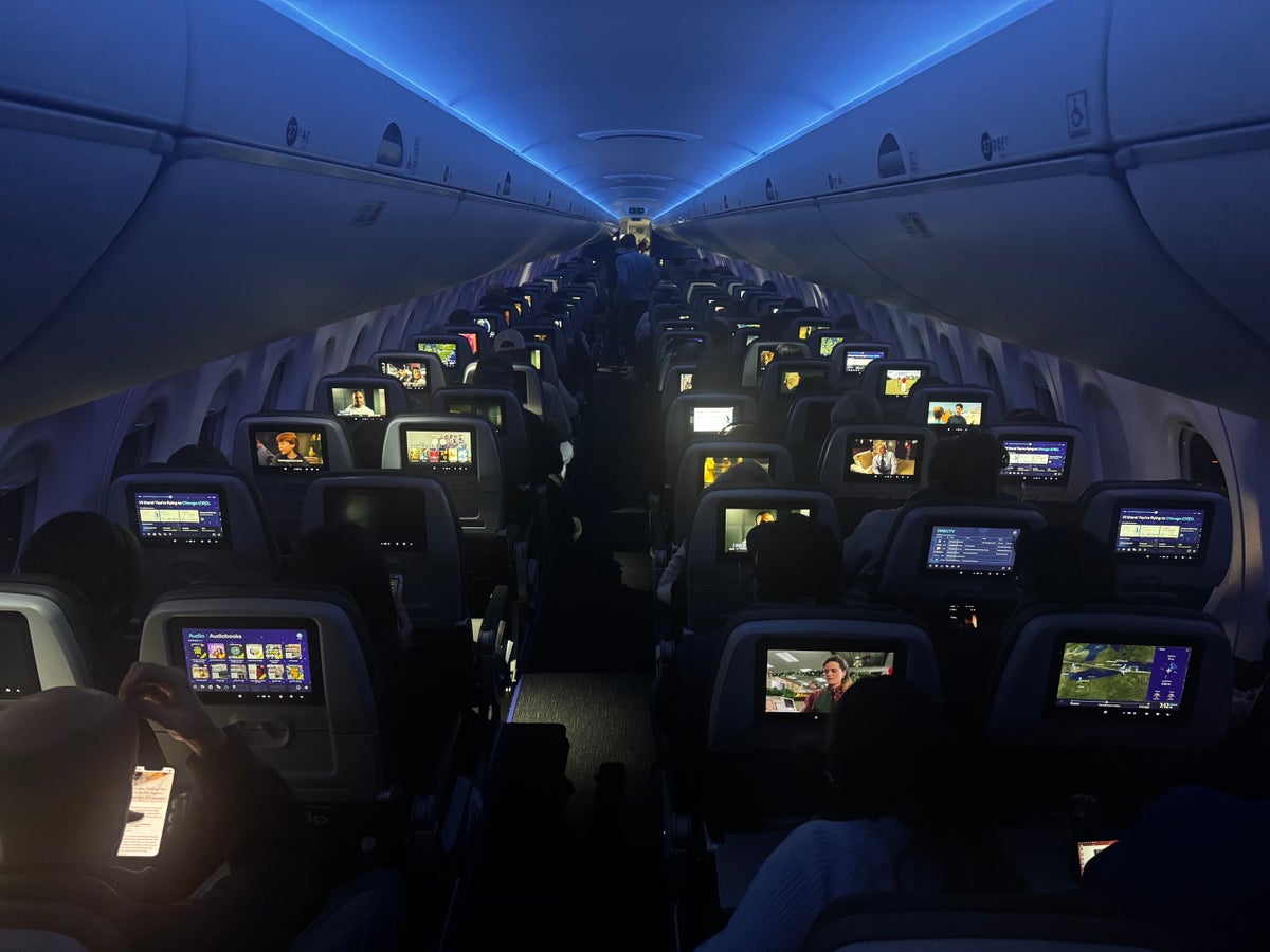 JetBlue A220 economy night overhead JetBlue A220 economy night overhead