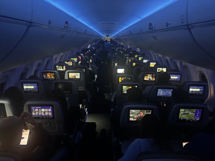 JetBlue A220 economy night overhead JetBlue A220 economy night overhead