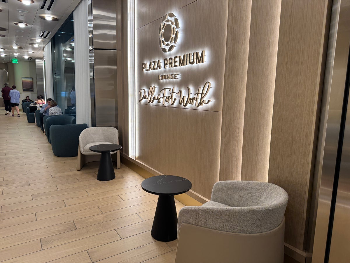 Plaza Premium Lounge DFW seats near signage