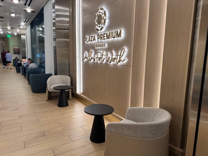 Plaza Premium Lounge DFW seats near signage