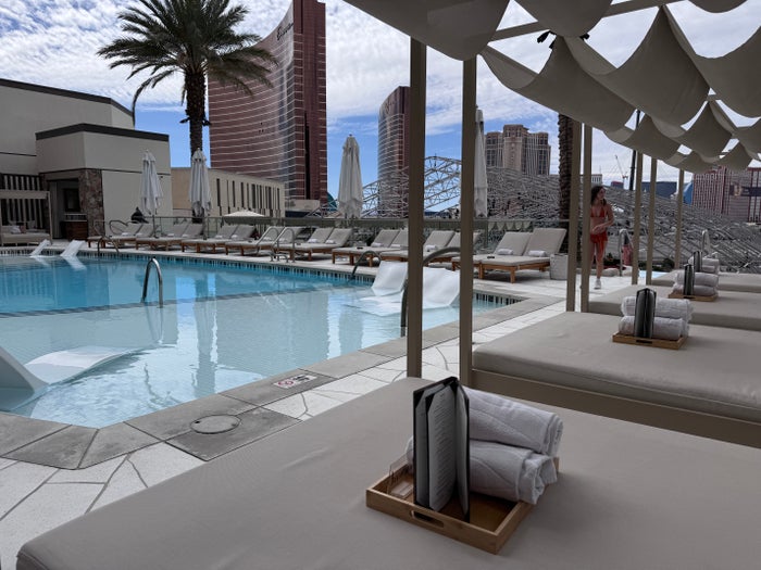 Resorts World Las Vegas Athena Infinity Pool daybed loungers with pool and Strip view