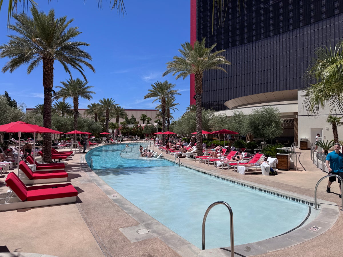 Resorts World Las Vegas pool main pool with red loungers and palm trees