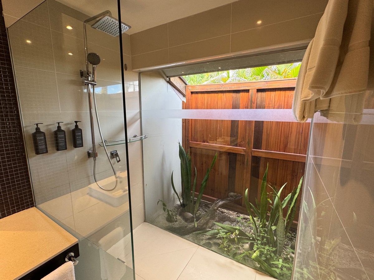 Sheraton Tokoriki Island Glass enclosed rain shower with outdoor garden courtyard view