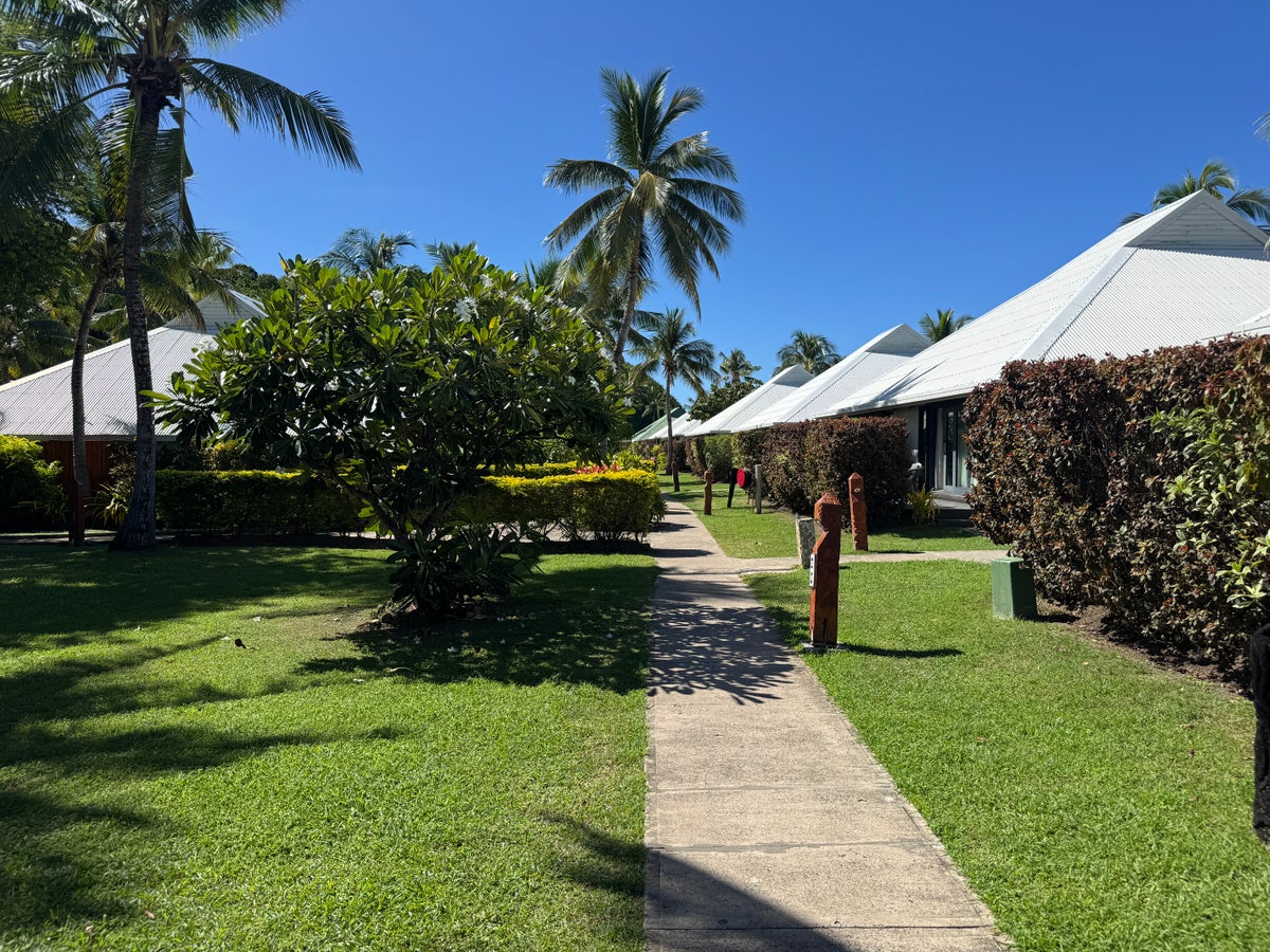 Sheraton Tokoriki Island Landscaped garden pathway between resort bungalows in sunshine