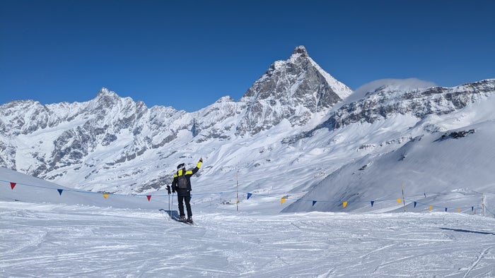 Skiing under the Matterhorn in Cervinia, Italy A skier takes a selfie in front of a pyramid-shaped mountain