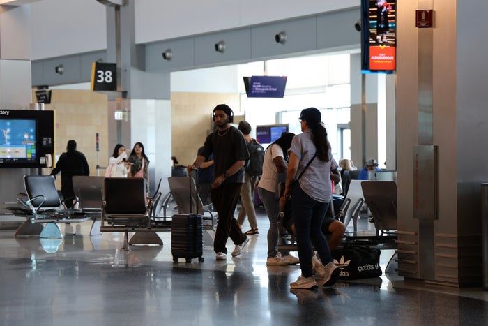 Travelers Walking Through Airport Upgraded Points LLC 3