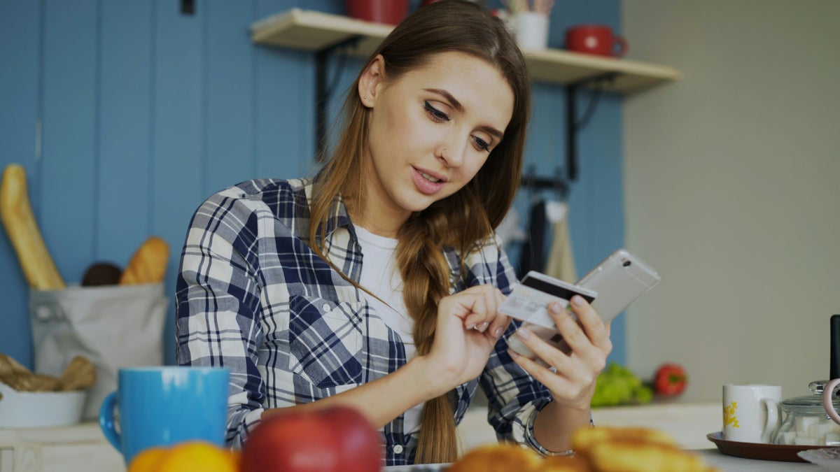 Woman with credit card making phone call