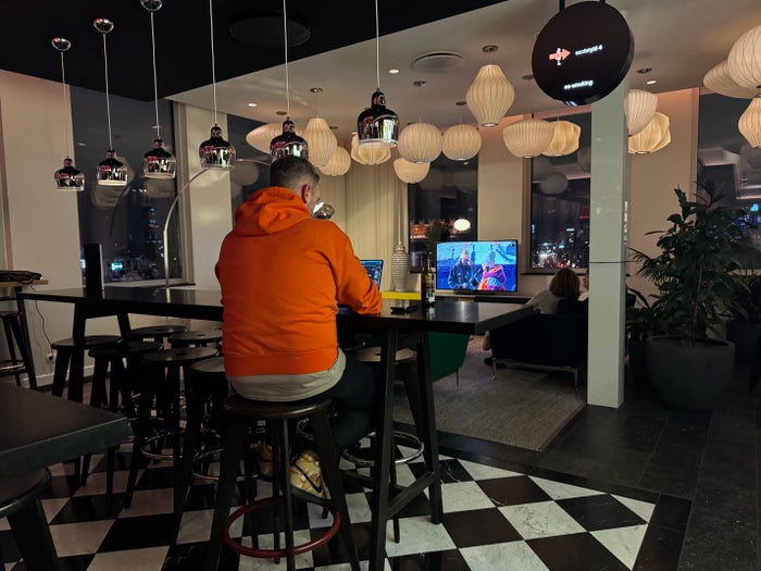 Family watching TV citizenM Copenhagen Radhuspladsen lobby TV area