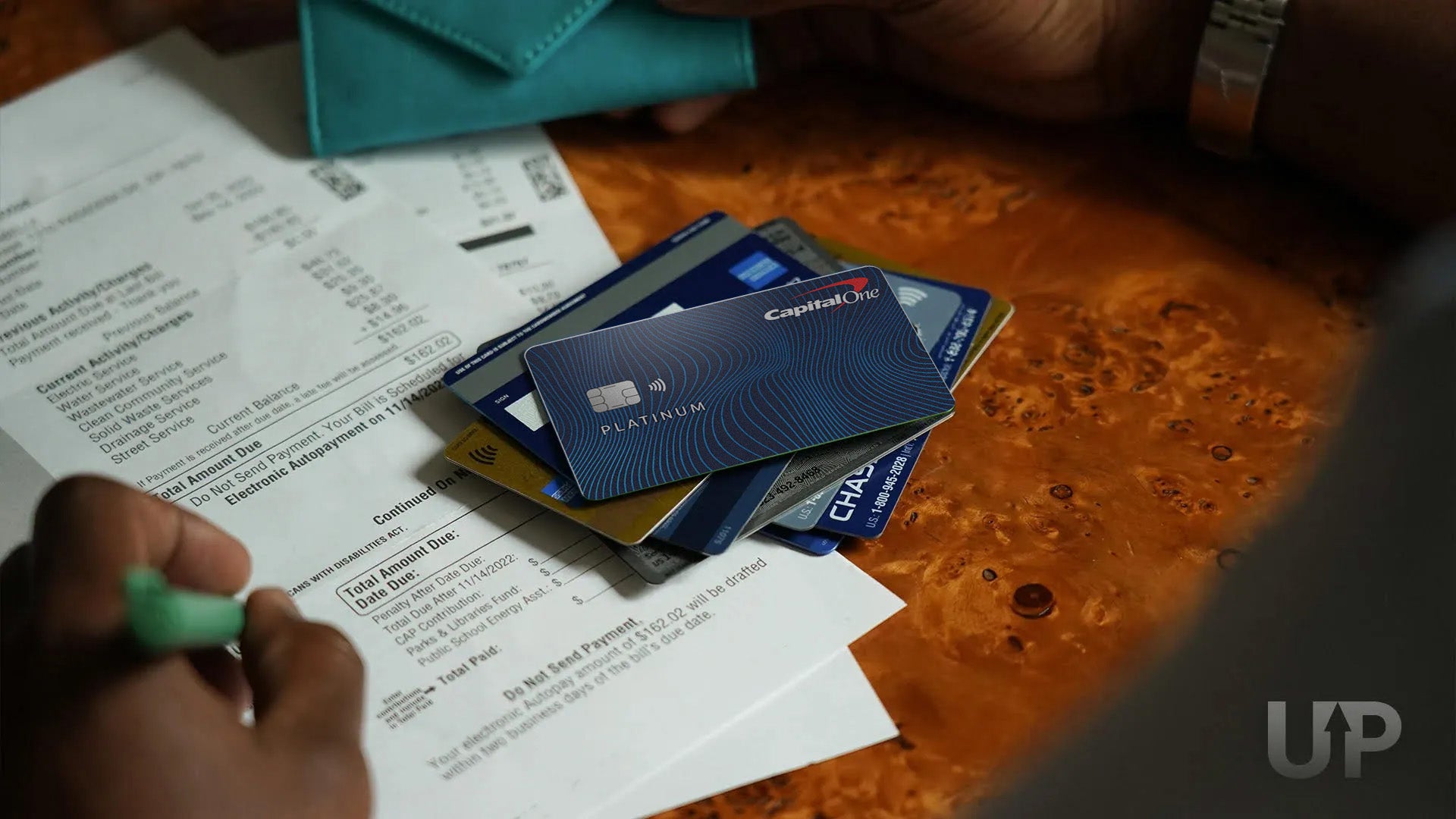 Capital One Platinum Stack of Credit Cards on top of utility bills Upgraded Points LLC 1