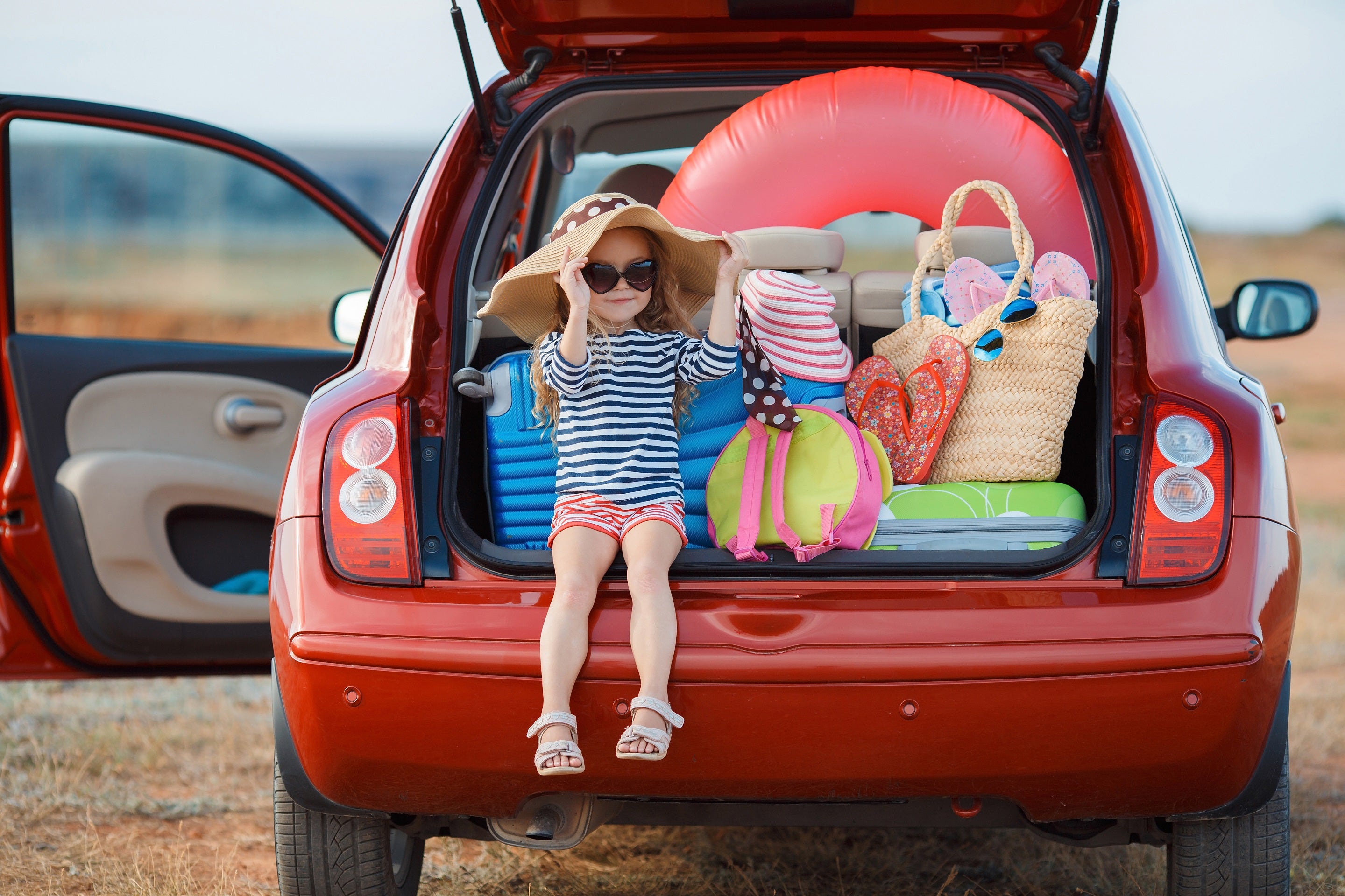 Family travel girl in trunk