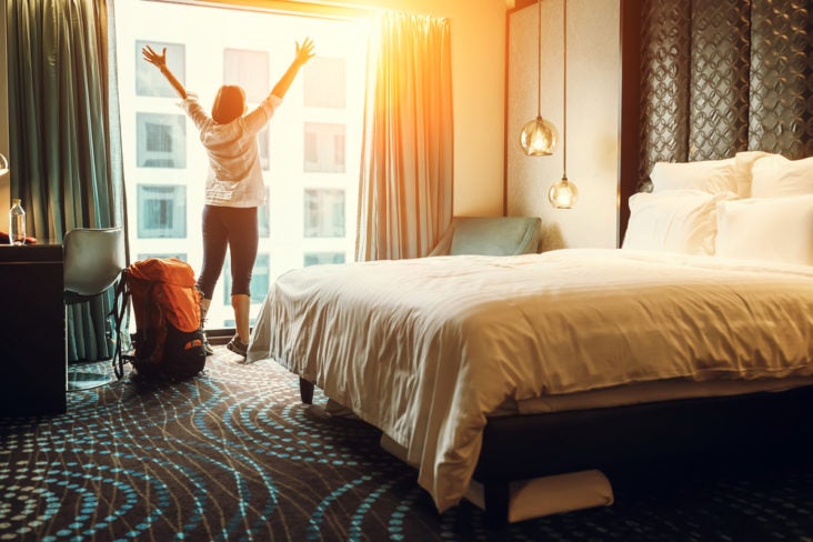 Happy backpacker traveler stay in high quality hotel