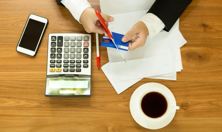 Cancel a Credit Card Man cutting a credit card to cancel