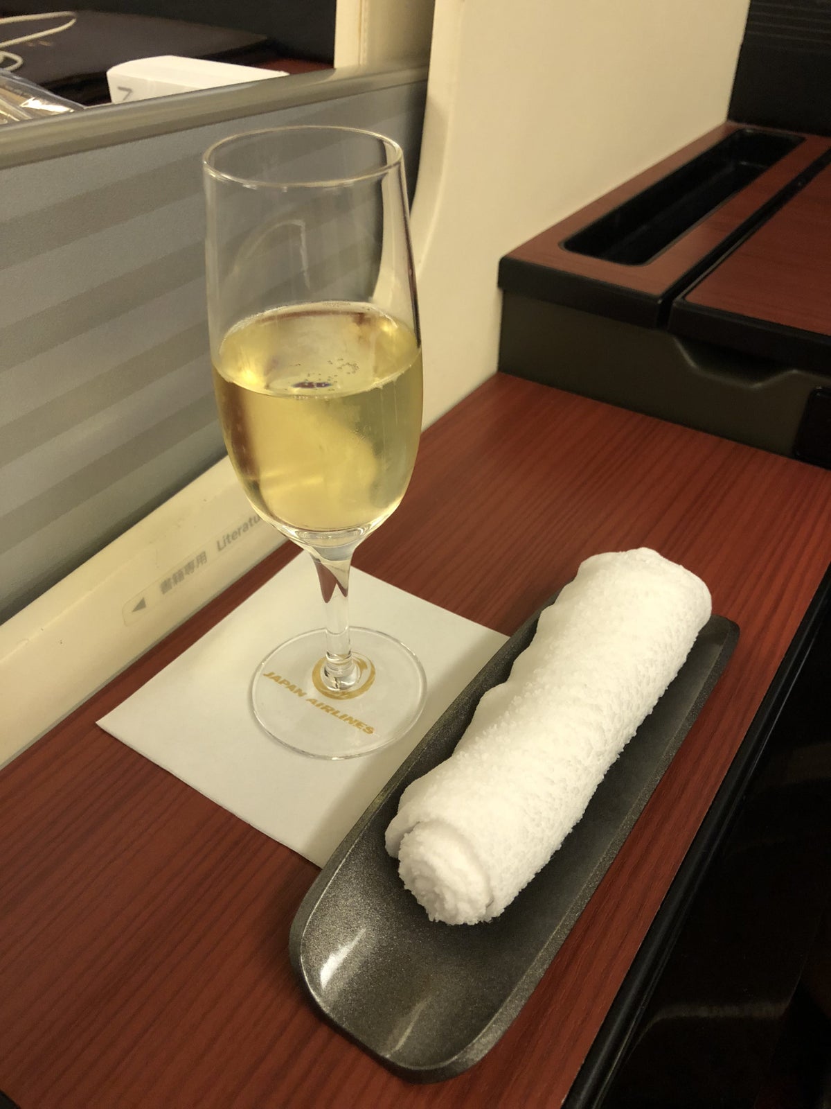 Japan Airlines 777 First Class Hot Towel and Pre-Departure Champagne
