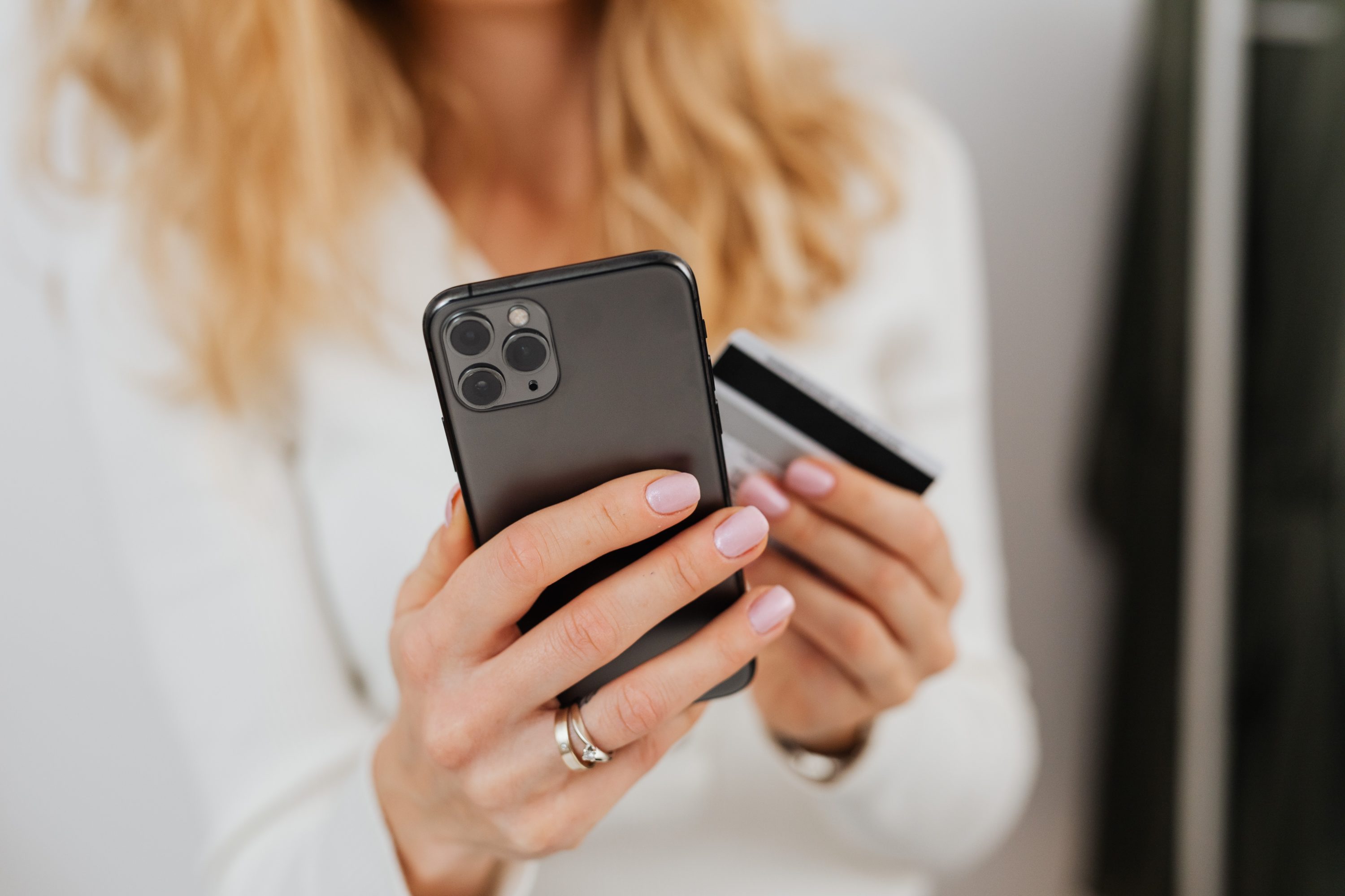 Woman holding credit card and smartphone