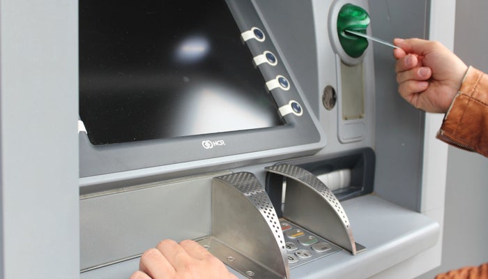 Person using ATM Person using ATM