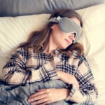 Lady sleeping with a sleep mask