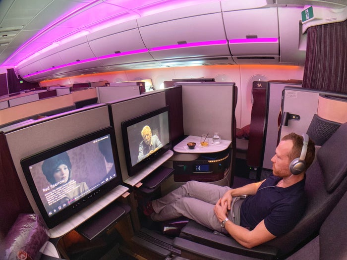 Qatar Qsuites A350, Passenger Enjoying Movie, Alex Miller of Upgraded Points Qatar Qsuites A350, Passenger Enjoying Movie, Alex Miller of Upgraded Points