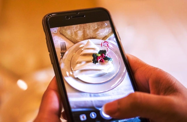 cell phone taking picture of place setting