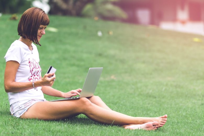 Woman Using Credit Card Online shopping outside