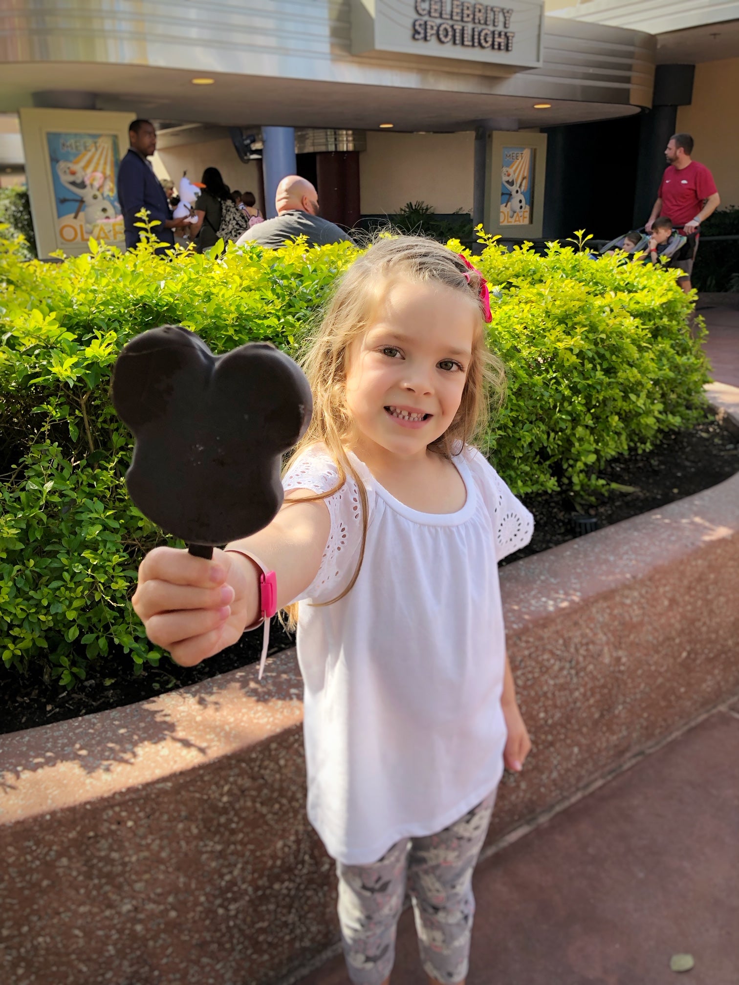 Girl holding Mickey Mouse ice cream at Disney's Hollywood Studios Girl holding Mickey Mouse ice cream at Disney's Hollywood Studios