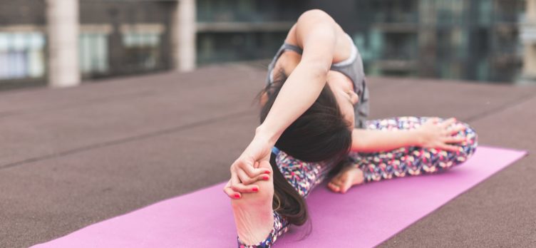 Lady practicing yoga on a yoga mat