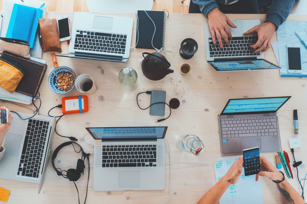 Group of People Working On Laptops At A Desk