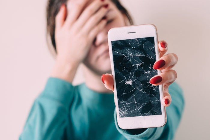 Woman Holding A Broken Cell Phone