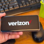 Person Holding A Smartphone Displaying a Verizon Logo