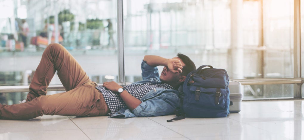 Man Laying on the Floor at An Airport
