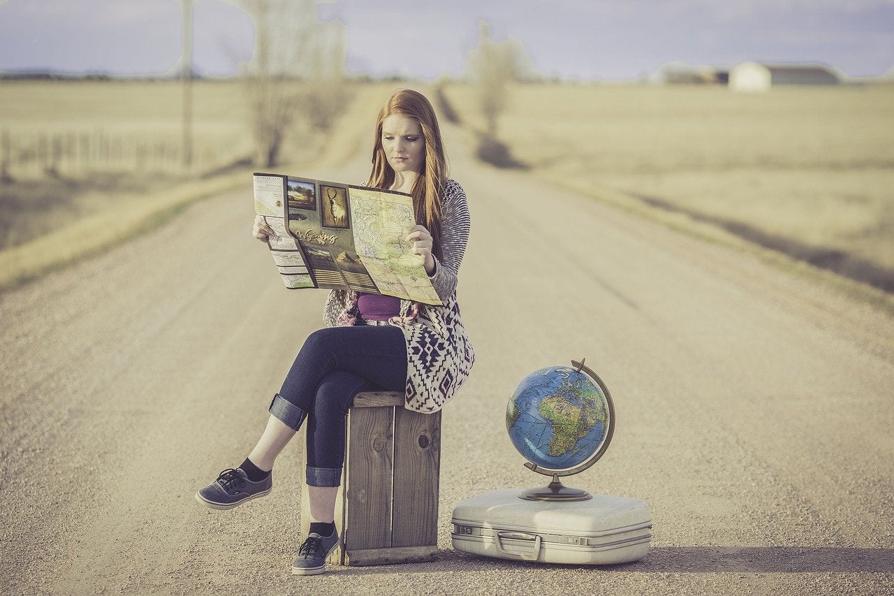 woman suitcase globe map searching highway