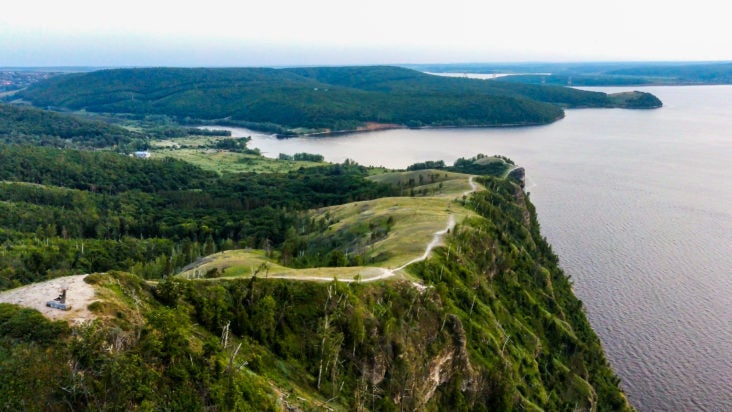 Region Aerial view of Zhiguli mountains with green trees and Volga river in Samarskaya Luka national park during summer evening, Samara region, Russia
