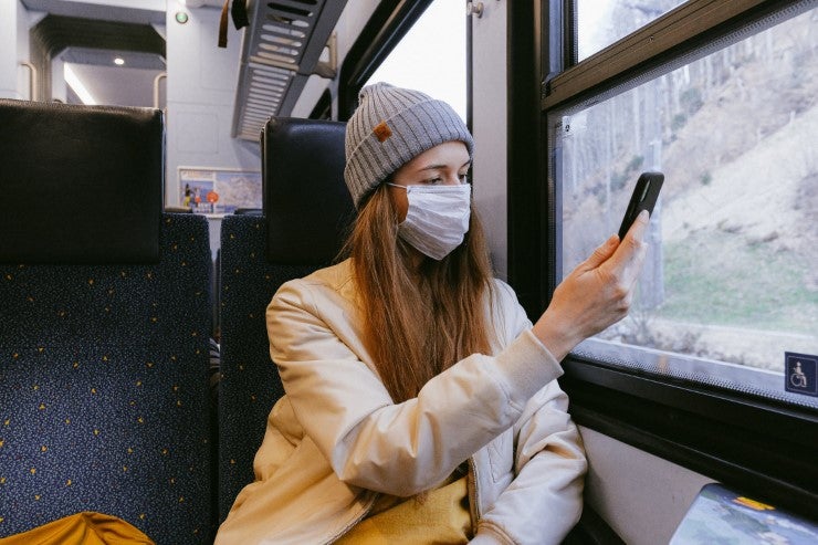 Woman On A Train Wearing A Medical Mask