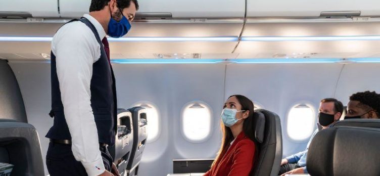 American Airlines masked flight attendant and passengers
