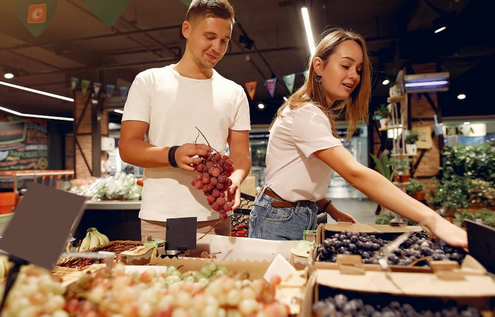 Couple buying grapes