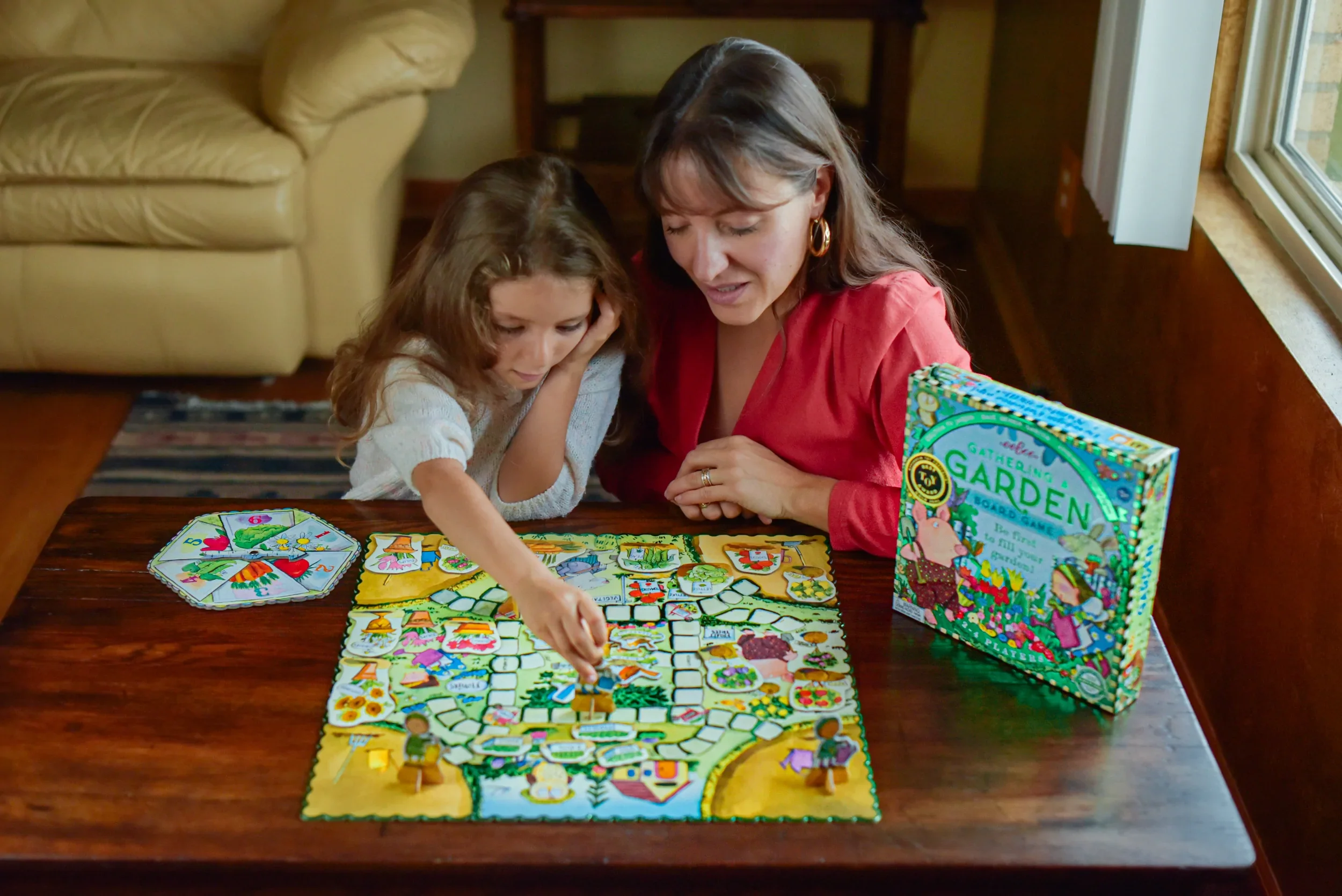 Mom and daughter playing Eeboo Gathering A Garden Board Game