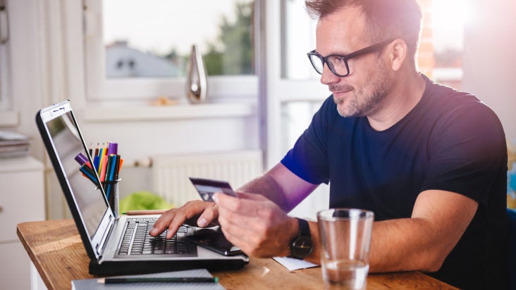 Man paying with credit card on smart phone man credit card computer