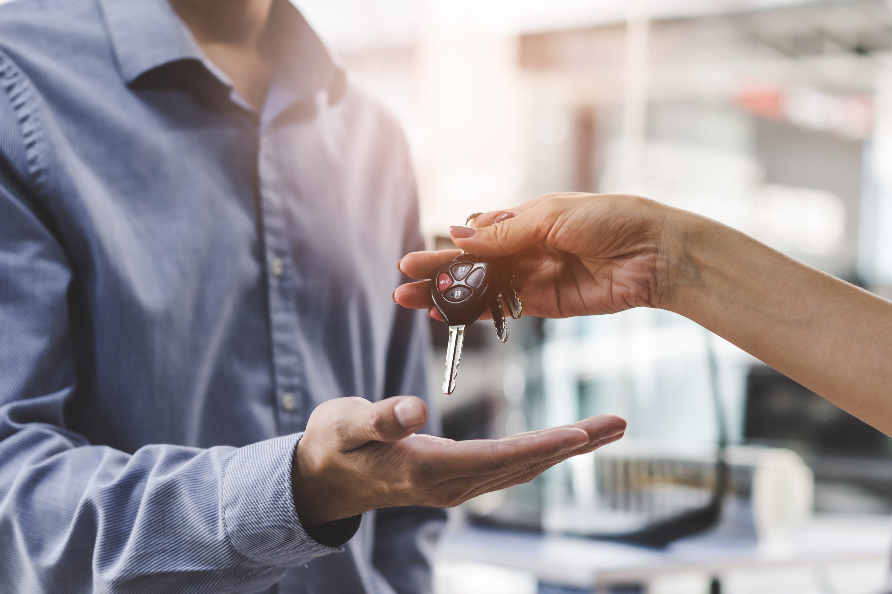 Car rental customer being handed keys