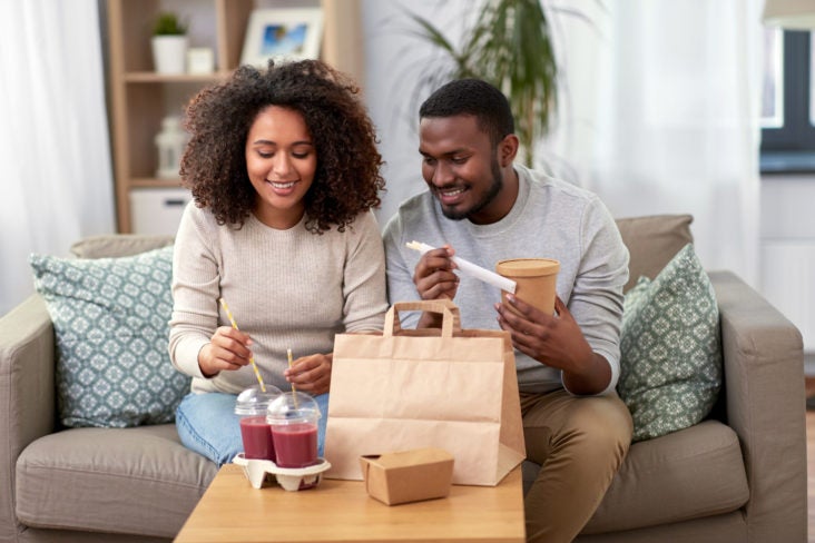 Couple eating takeout delivery food Couple eating takeout delivery food